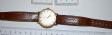 orologio marca OMEGA modello CENTURY  avente quadrante bianco e cinturino marrone
